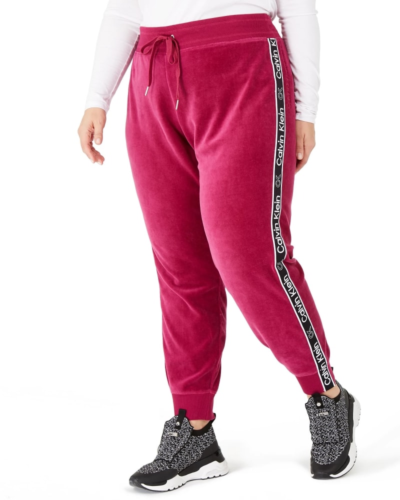Front of a model wearing a size 1X Calvin Klein Women's Logo Jogging Pants Dark Red 1X in Red by Calvin Klein. | dia_product_style_image_id:307300